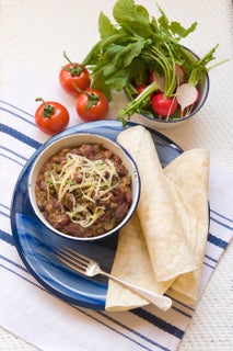 Mexican frijoles with radish and tomato salad