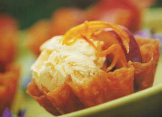 Lemon cheesecake ice cream with plums in sweet wine