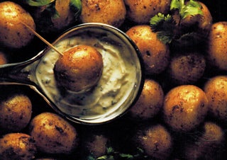 Spicy new potatoes with roasted garlic dressing