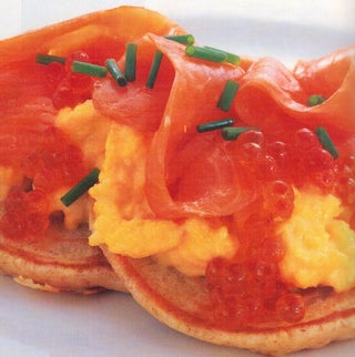 Blini with creamy scrambled eggs and smoked salmon